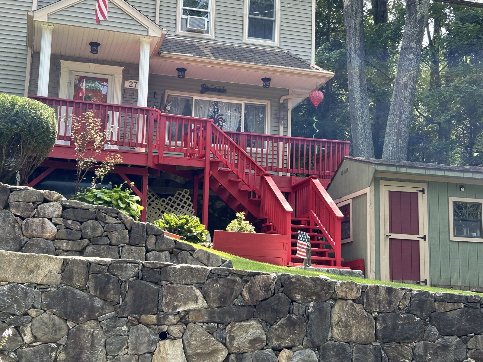 Fieldstone retaining wall and painted deck stairs